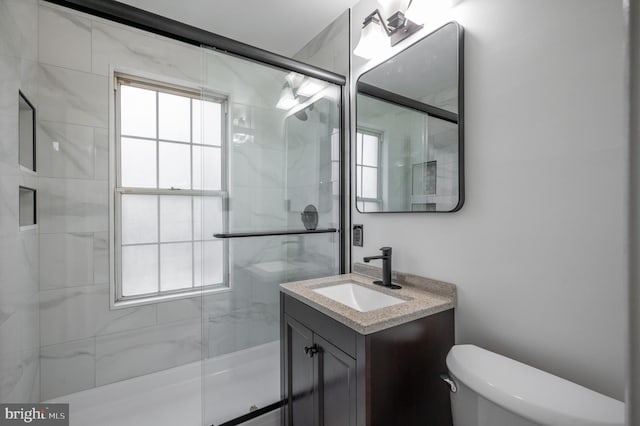 bathroom featuring an enclosed shower, toilet, and vanity