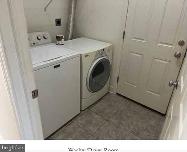 washroom featuring separate washer and dryer and light tile patterned floors