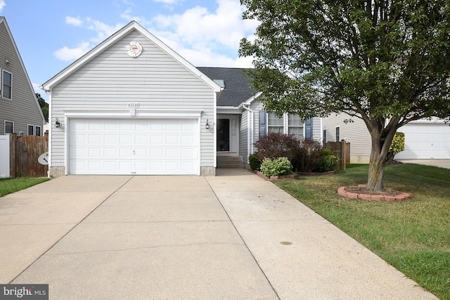 view of front of property featuring a garage and a front lawn