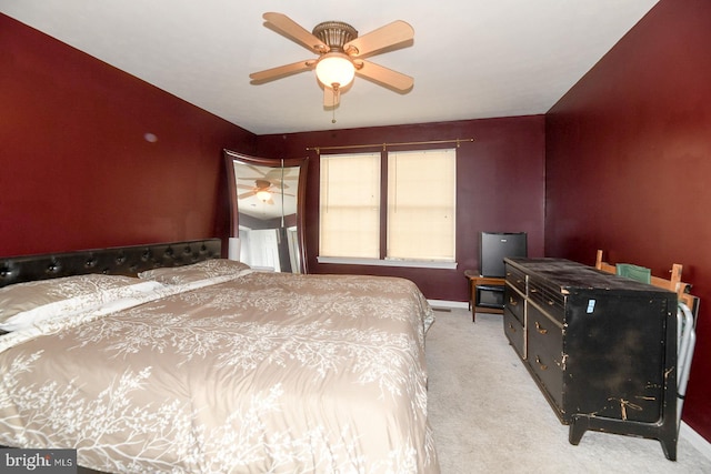 bedroom featuring light carpet and ceiling fan