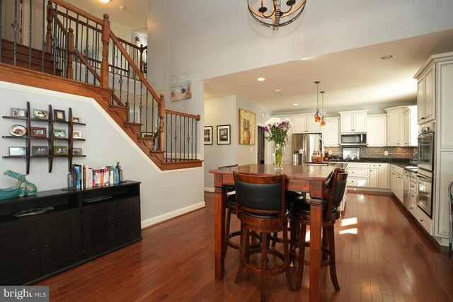 dining area with stairs, baseboards, dark wood-style flooring, and recessed lighting