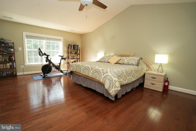 bedroom with lofted ceiling, a ceiling fan, baseboards, and dark wood-style flooring