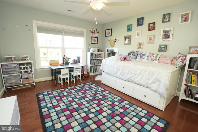 bedroom with ceiling fan, dark wood-style flooring, visible vents, and baseboards