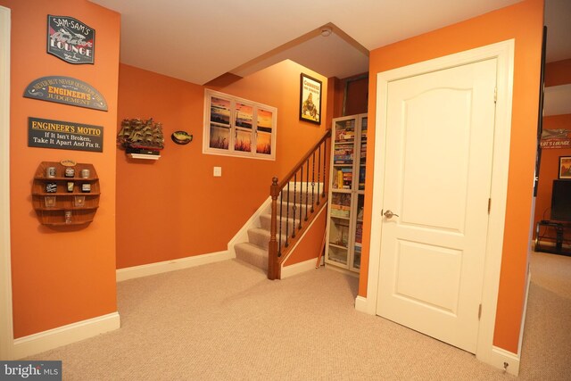 staircase with carpet flooring and baseboards