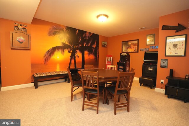 carpeted dining space with baseboards and visible vents