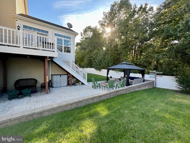 view of yard featuring stairs, a gazebo, a patio area, and fence