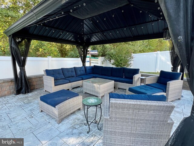 view of patio / terrace with a fenced backyard, a gazebo, and an outdoor hangout area