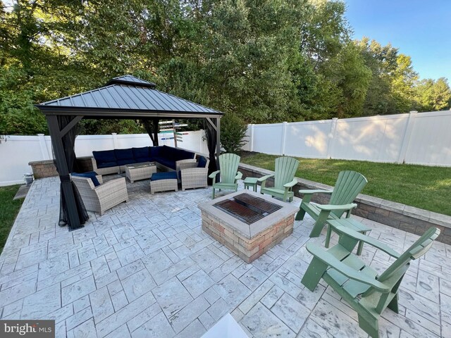 view of patio featuring a gazebo, a fenced backyard, and an outdoor living space with a fire pit