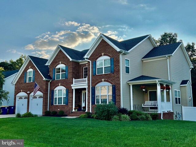 view of front of property featuring driveway, an attached garage, a front yard, and brick siding