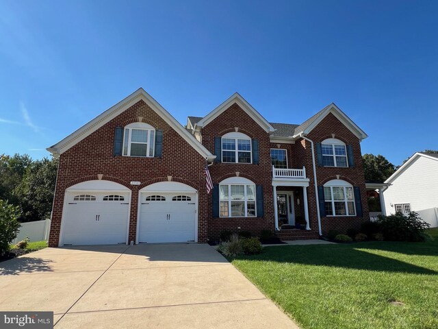 view of front facade with an attached garage, brick siding, driveway, and a front lawn