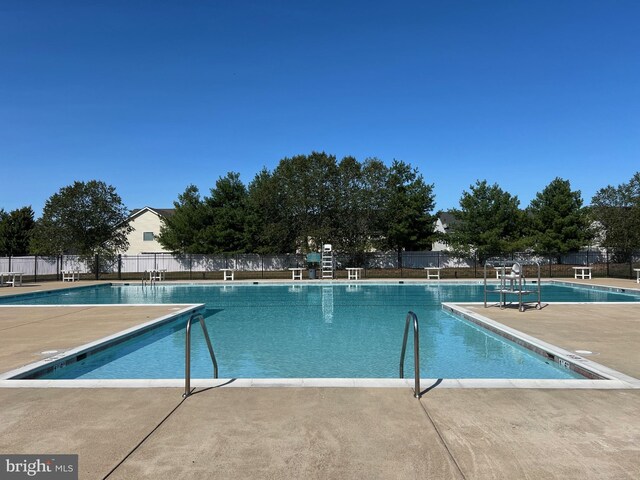 pool featuring fence and a patio