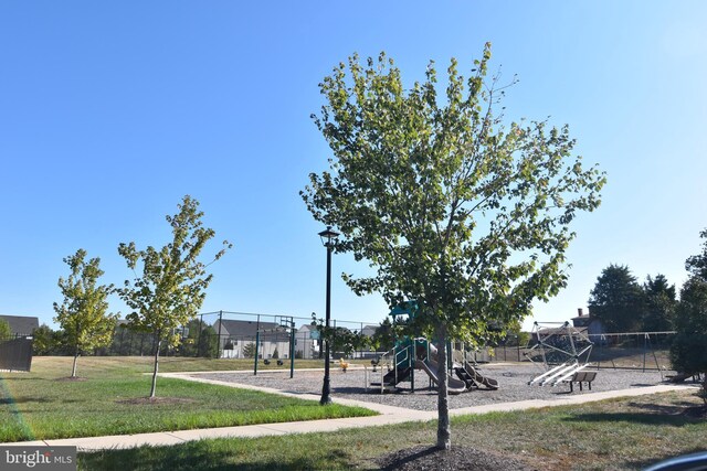 surrounding community featuring playground community, a yard, and fence