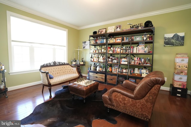 sitting room featuring ornamental molding, dark wood finished floors, and baseboards