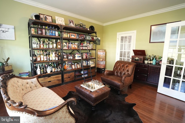 sitting room with dark wood-style floors and crown molding