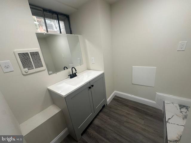 bathroom with visible vents, wood finished floors, vanity, and baseboards