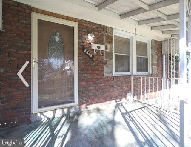 view of exterior entry with covered porch