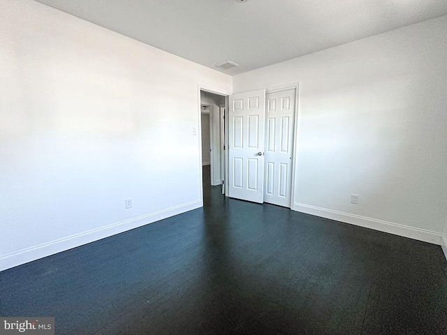 unfurnished room featuring visible vents and baseboards