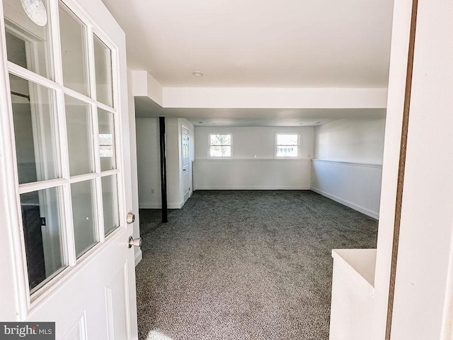 carpeted spare room with baseboards