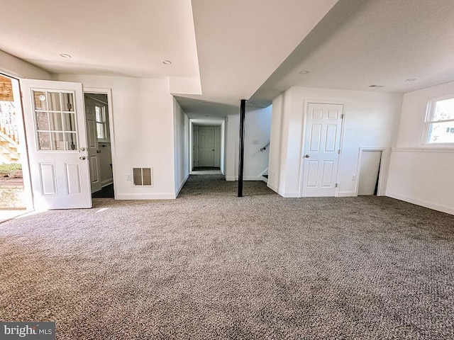 interior space featuring carpet floors, baseboards, and visible vents