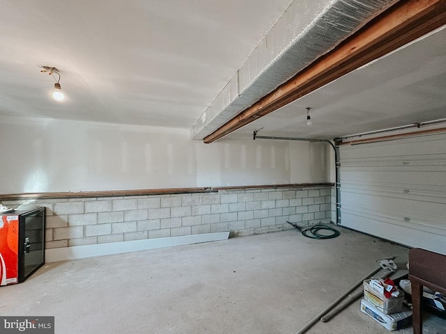 garage with concrete block wall