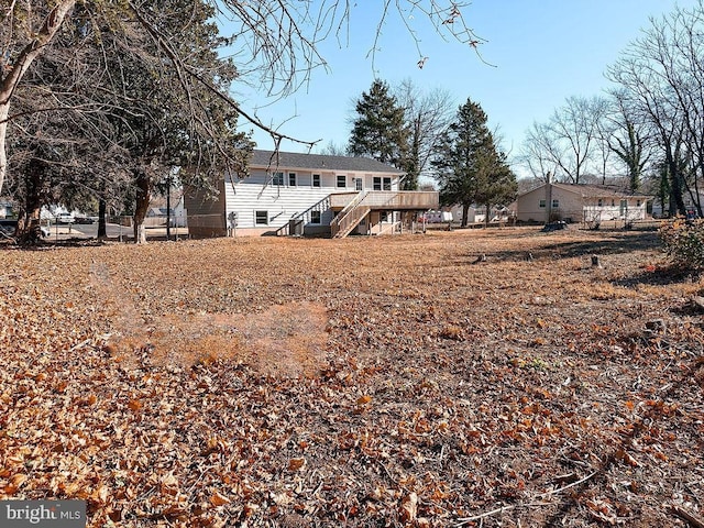 exterior space featuring a deck and stairs