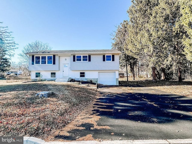 bi-level home with a garage and driveway