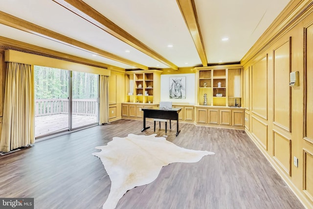 interior space featuring a decorative wall, beamed ceiling, and light wood finished floors