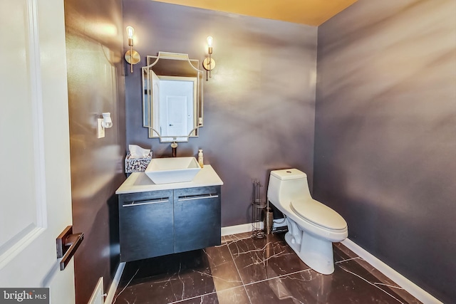 bathroom featuring toilet and vanity