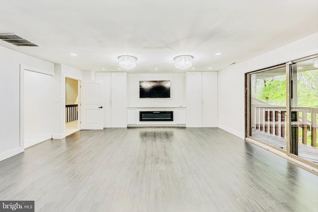 unfurnished living room featuring hardwood / wood-style floors