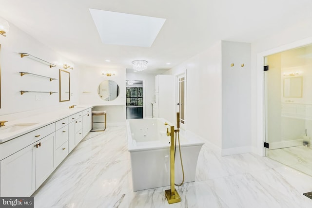 bathroom featuring a skylight, independent shower and bath, and vanity