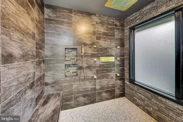 bathroom with a tile shower