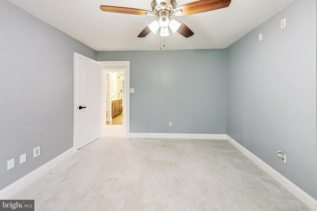 carpeted empty room featuring ceiling fan