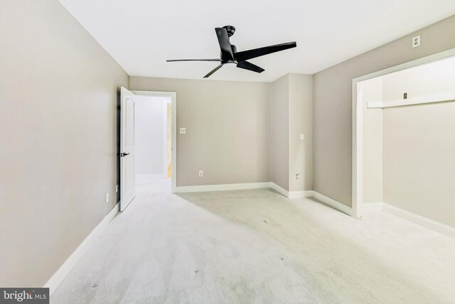 empty room featuring light colored carpet and ceiling fan