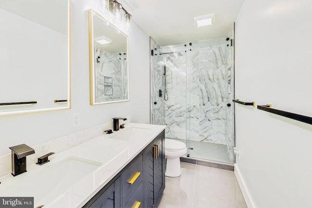 full bathroom with double vanity, toilet, a marble finish shower, and a sink