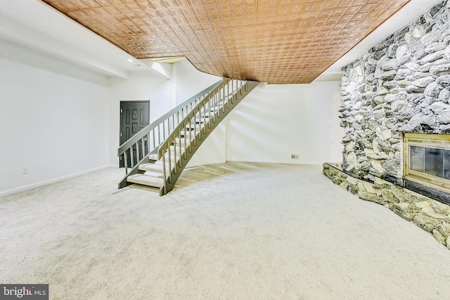 basement featuring a fireplace and carpet