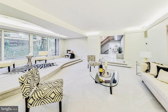 carpeted living area with stairway