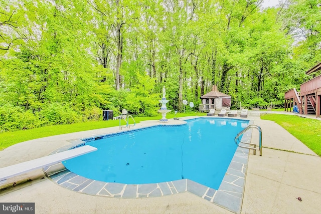 view of swimming pool featuring a diving board, a patio, and a gazebo