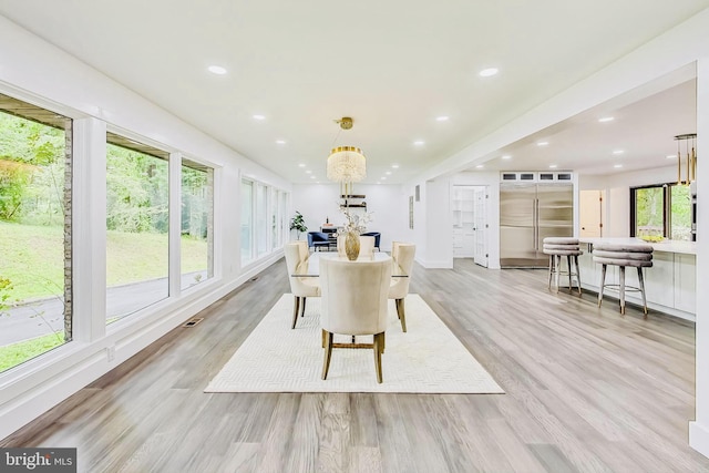 dining space featuring a healthy amount of sunlight and light hardwood / wood-style floors