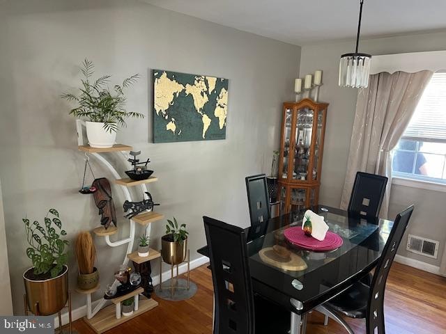 dining space featuring a notable chandelier and hardwood / wood-style flooring