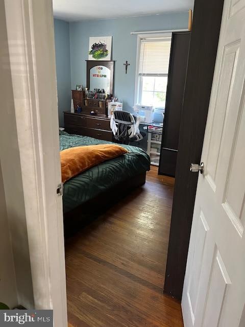 bedroom featuring dark hardwood / wood-style flooring