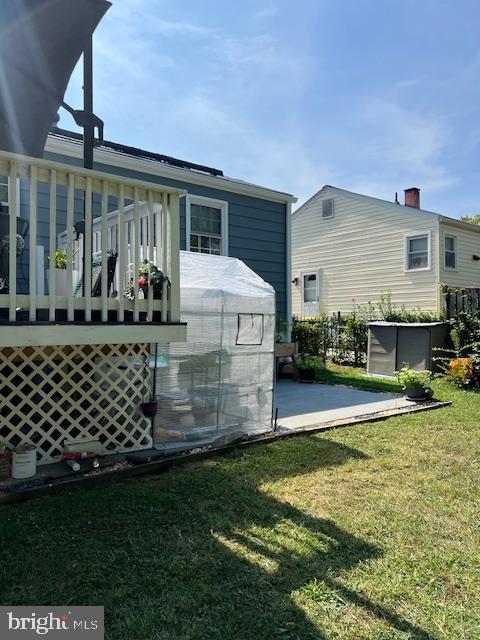 rear view of house featuring a patio and a lawn