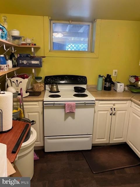 kitchen featuring white cabinetry and white electric range oven