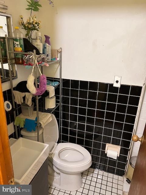 bathroom featuring tile walls, tile patterned flooring, vanity, and toilet