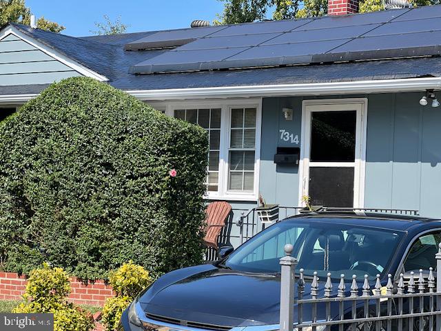 doorway to property featuring solar panels