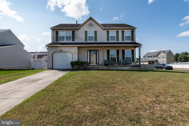 view of front of house featuring a garage and a front yard