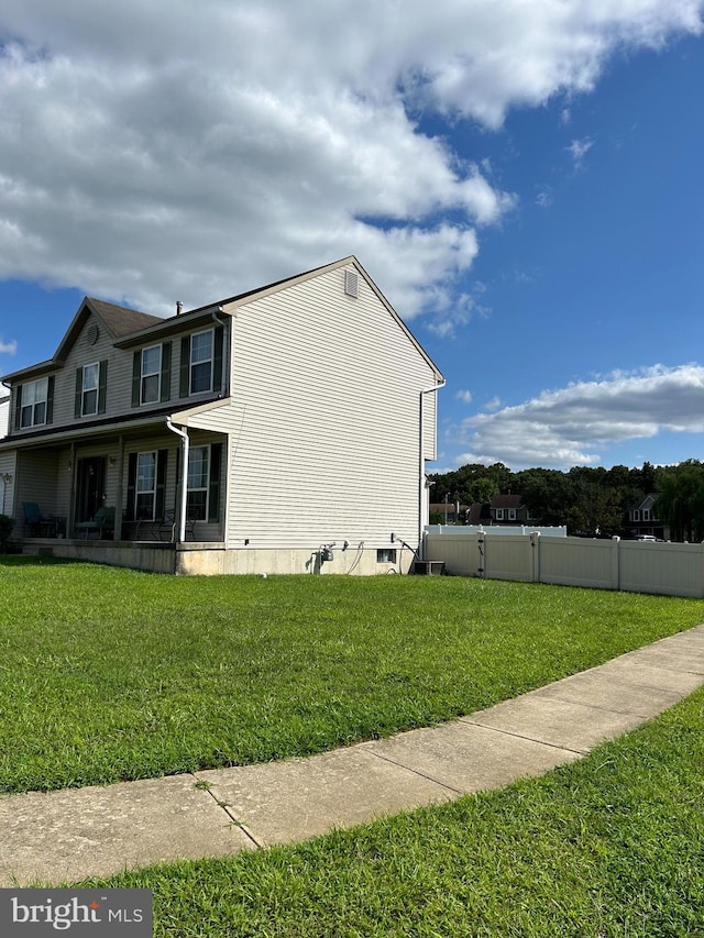 view of side of property with a lawn