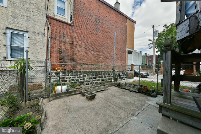 view of home's exterior featuring a gate, fence, and a patio