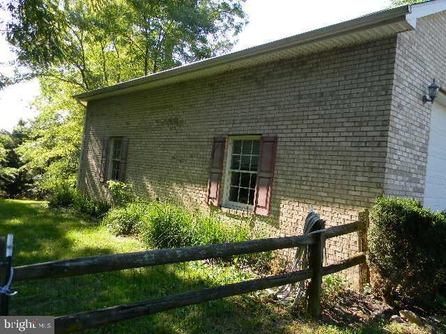 view of side of home featuring a yard