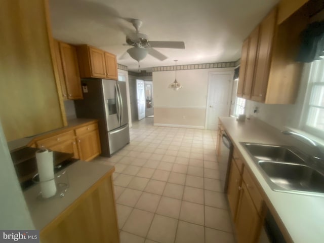 kitchen featuring light countertops, a sink, stainless steel fridge with ice dispenser, and ceiling fan