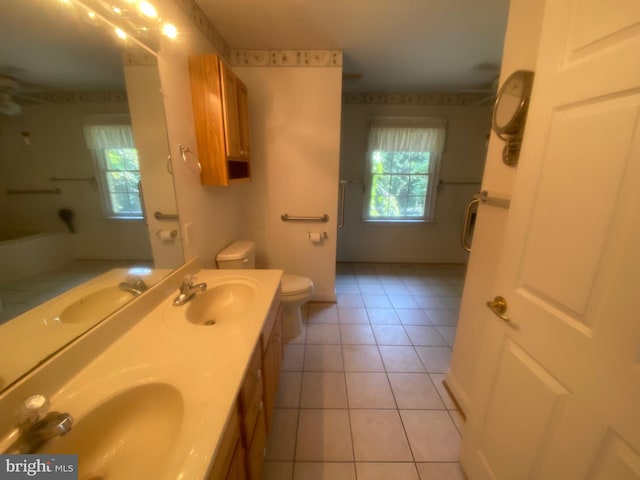 bathroom with a healthy amount of sunlight, a sink, and tile patterned floors